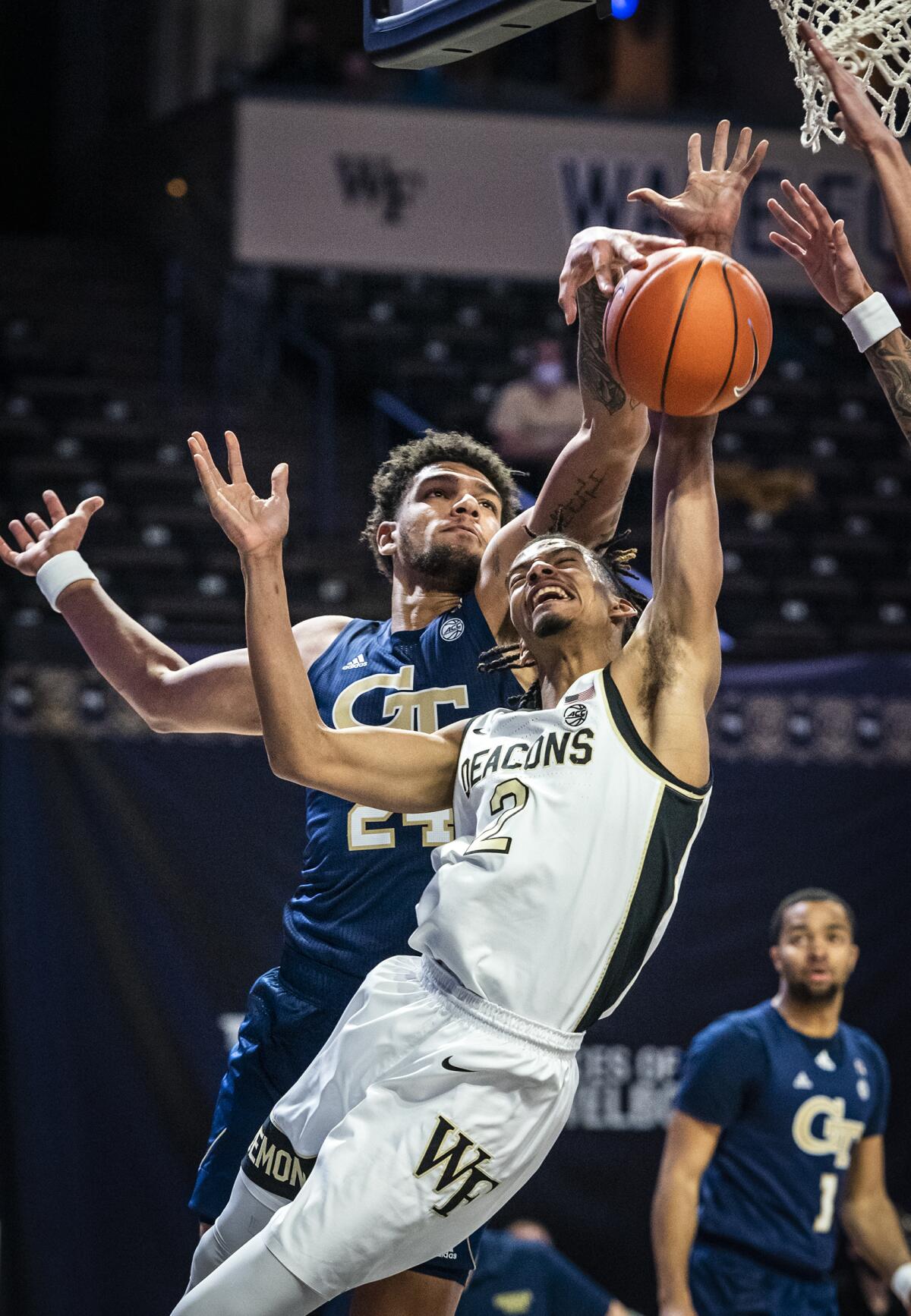 Georgia Tech forward Rodney Howard (24) blocks a shot from Wake Forest guard Jalen Johnson (2) during an NCAA college basketball game Friday, March 5, 2021, in Winston-Salem, N.C. (Andrew Dye/The Winston-Salem Journal via AP)