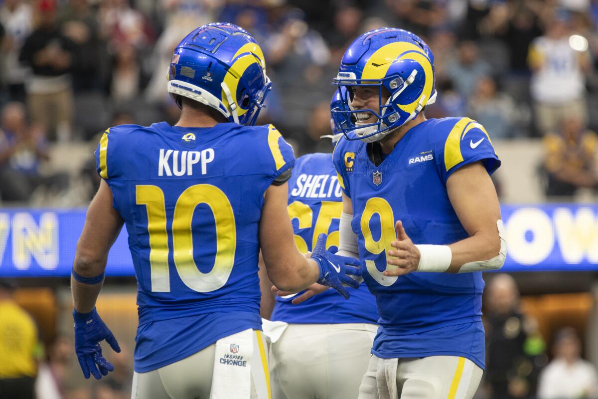 Rams quarterback Matthew Stafford (9) congratulates Cooper Kupp (10) after his touchdown catch.