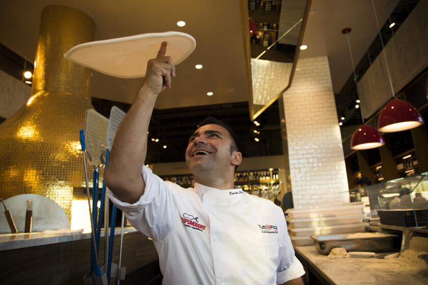 Chef Davida Civitiello tosses homemade pizza dough at Rossopomodoro Pizzeria Napoletana inside the new Eataly at the Westfield Century City Plaza.