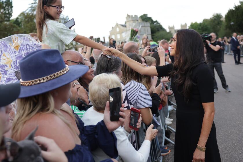 WINDSOR, ENGLAND - SEPTEMBER 10: Meghan, Duchess of Sussex meets members of the public on the long Walk at Windsor Castle after viewing flowers and tributes to HM Queen Elizabeth on September 10, 2022 in Windsor, England. Crowds have gathered and tributes left at the gates of Windsor Castle to Queen Elizabeth II, who died at Balmoral Castle on 8 September, 2022. (Photo by Chris Jackson/Getty Images)