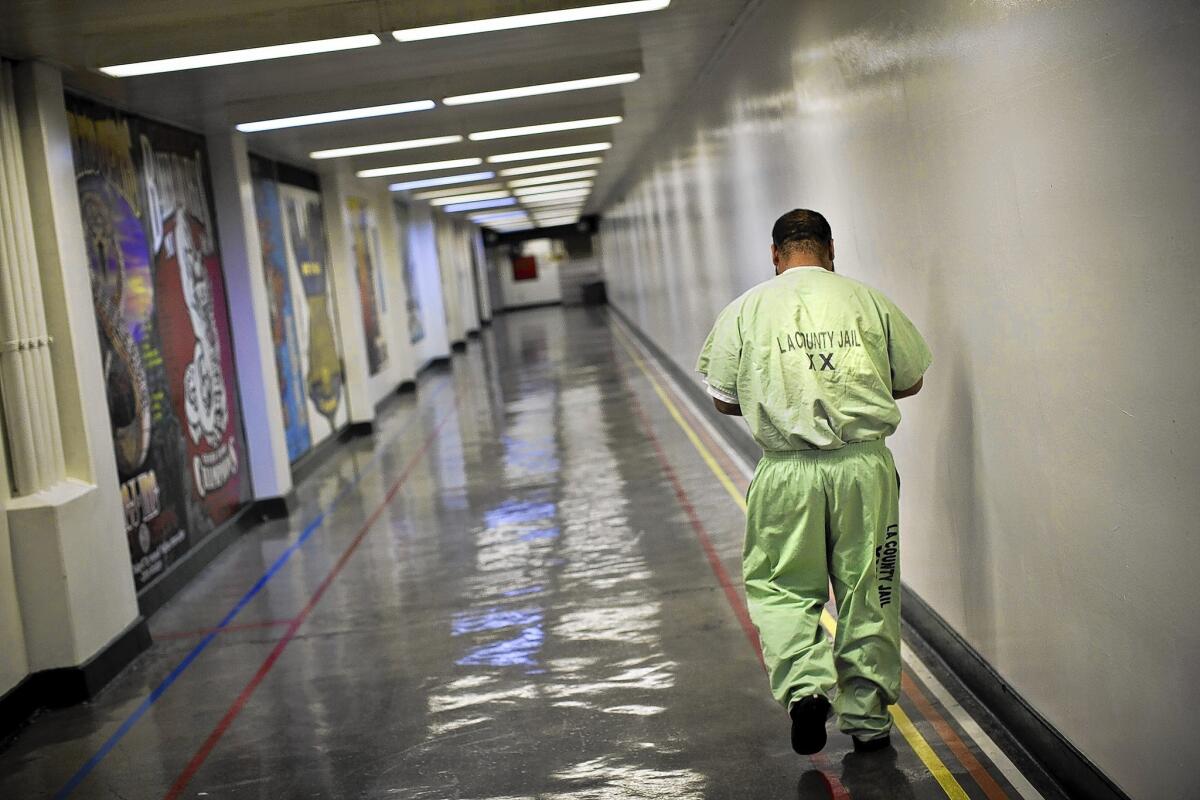An inmate walks a corridor at the Men's Central Jail in downtown L.A. Concerned about deteriorating facilties, county supervisors want the jail replaced.