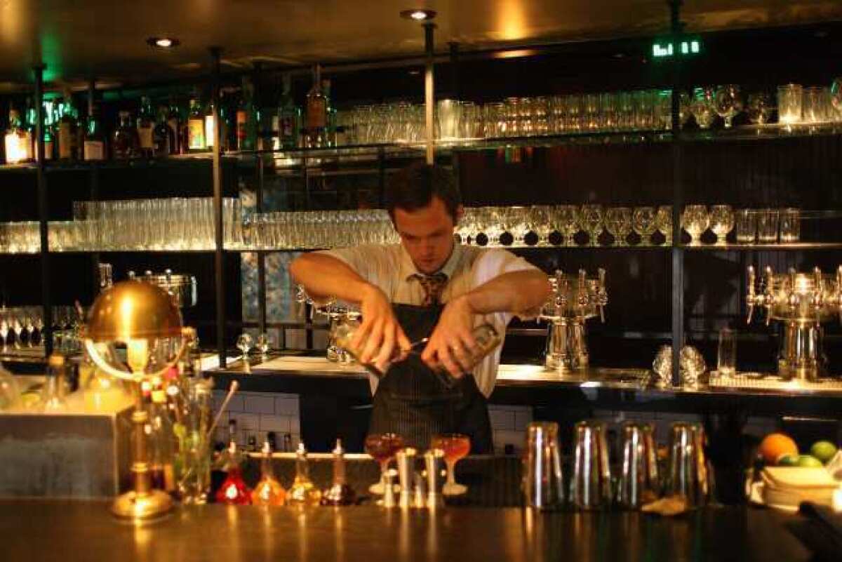 Mixologist John Coltharp pours at the Parish, a new downtown gastropub by Tasting Kitchen chef Casey Lane.