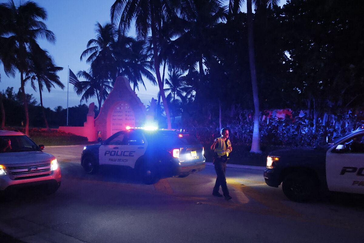 Police direct traffic outside an entrance to former President Donald Trump's Mar-a-Lago estate, Monday.