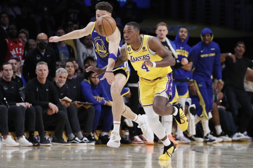 Lakers guard Lonnie Walker IV steals the ball from Warriors guard Klay Thompson.