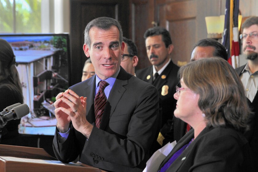 Mayor Eric Garcetti, left, is joined by seismologist Lucy Jones, his earthquake advisor, as he announces his retrofit plan in December.
