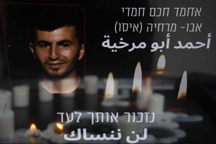 Candles lights during a vigil for Ahmad Abu Murkhiyeh, a 25-year-old Palestinian man who was found decapitated in the West Bank city of Hebron, at an LGBTQ shelter in Tel Aviv, Israel, Oct. 7, 2022. Accounts that Abu Murkhiyeh was a gay man who had sought asylum in Israel has turned the tragedy into a socially and politically explosive case, reflecting divergent views from two very different societies. Hebrew and Arabic reads "we will remember you forever". (AP Photo//Oded Balilty)