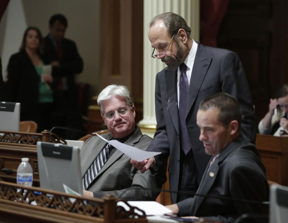 State Sen. Jerry Hill (D-San Mateo), center, discusses legislation with Sen. Andy Vidak (R-Hanford), left, and then-Sen. Steve Knight (R-Palmdale) in 2014.