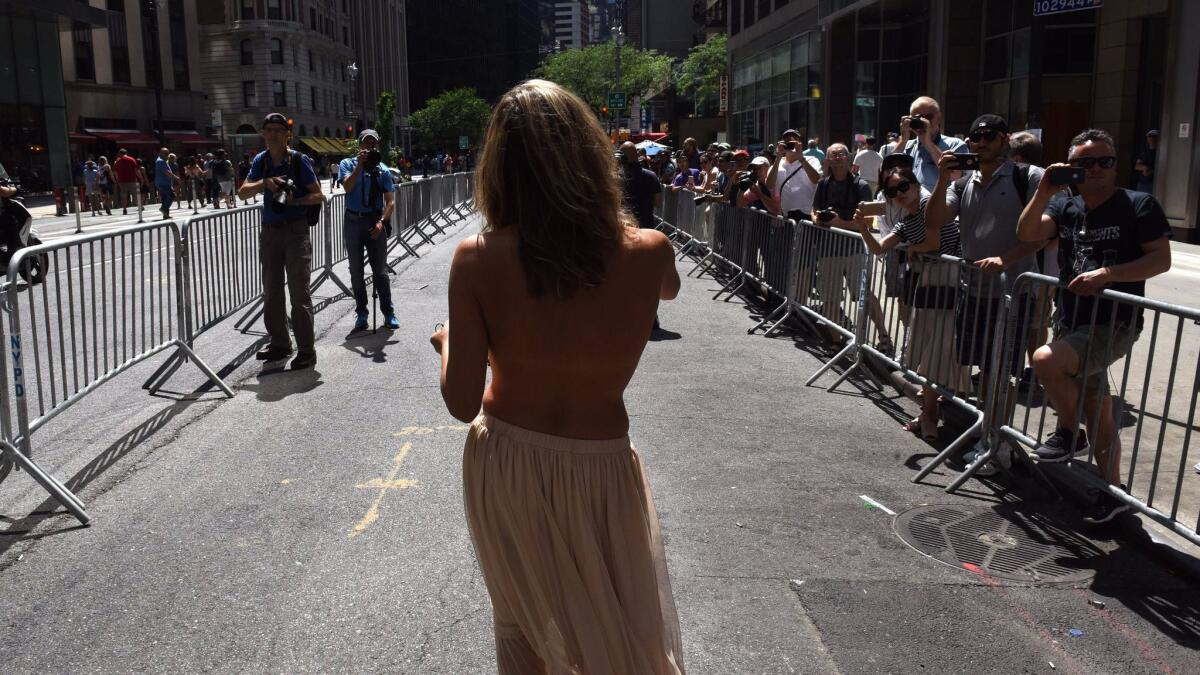 People participate in a march during International Go Topless Day in New York Aug. 26.