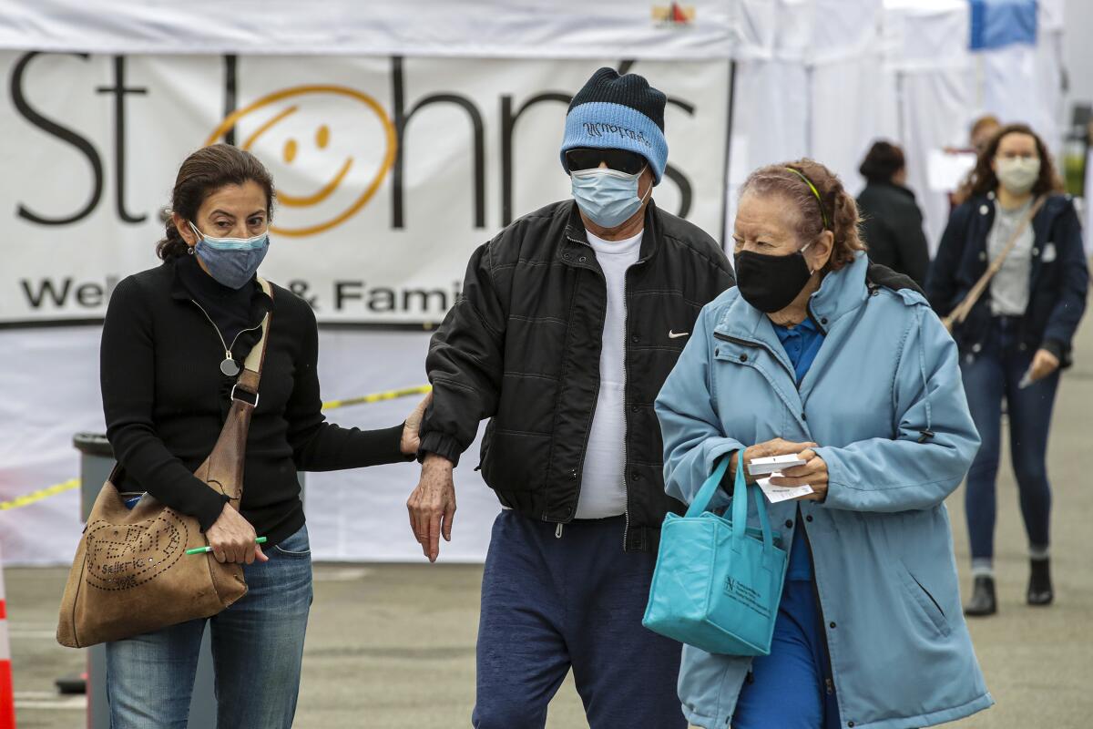 People walk to a COVID-19 vaccination site in East Los Angeles.