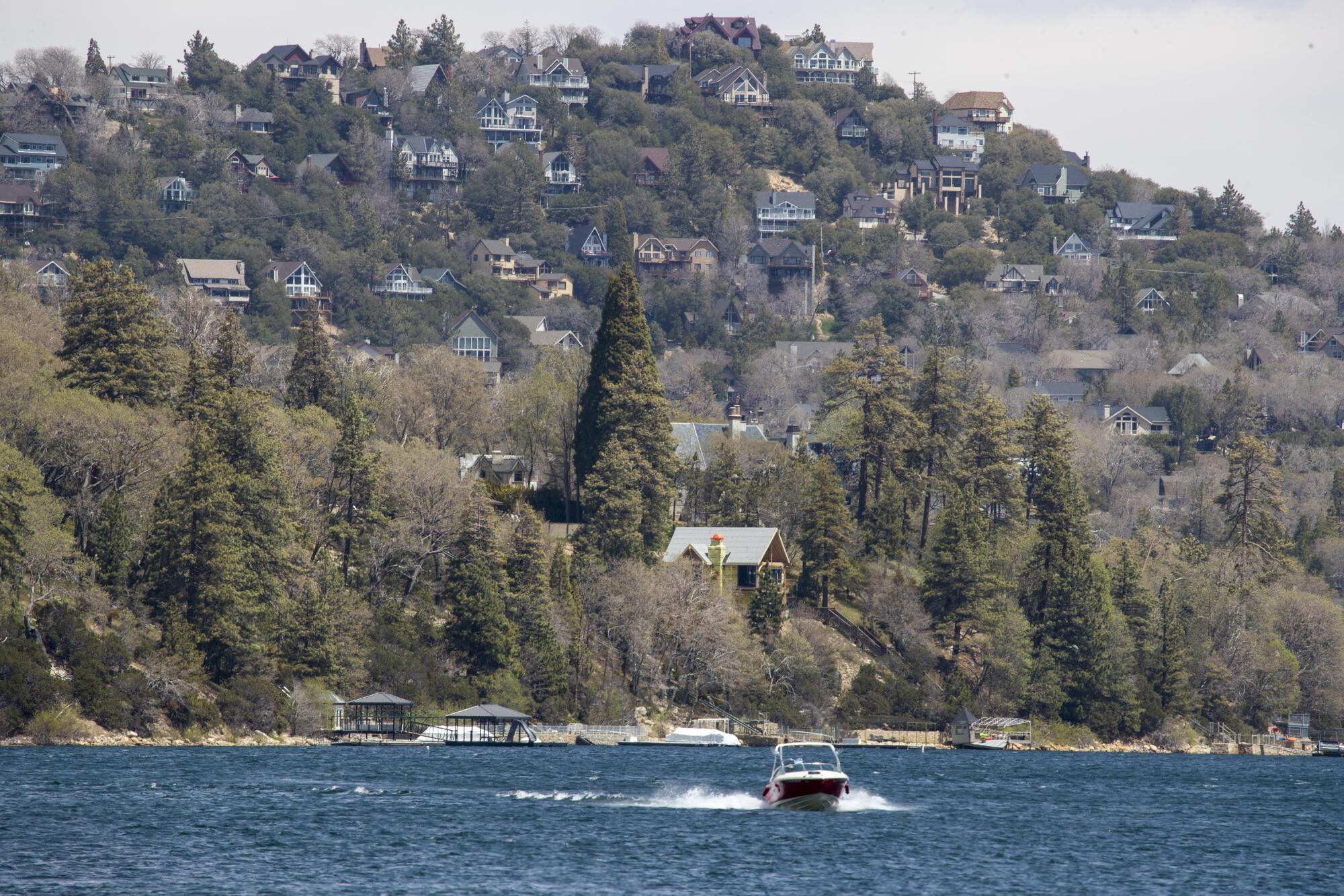 A boat cruises glides along a lake