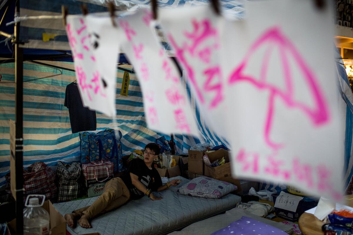A pro-democracy activist looks out from his tent on a street in Mong Kok District on November 24 in Hong Kong.
