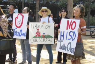 People hold up signs at a news conference on Friday, March 3, 2023, in Houston while protesting the proposed takeover of the city's school district by the Texas Education Agency. Local and federal officials say state leaders are preparing to take over the Houston Independent School District over allegations of misconduct by district board members and the yearslong failing performance of one campus. ( Juan A. Lozano/AP Photo)