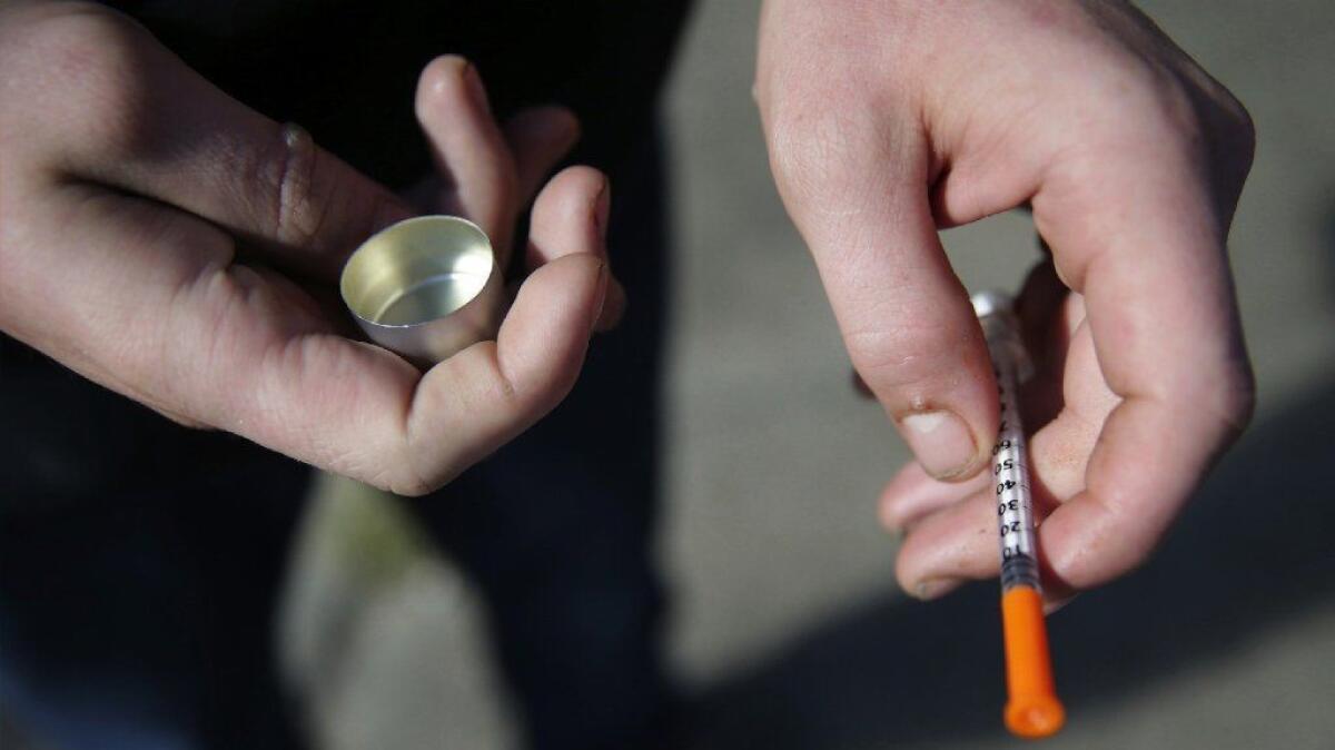 A fentanyl user holds a needle in Philadelphia, Penn. A Centers for Disease Control and Prevention report released Thursday called fentanyl the third wave of the opioid epidemic, behind prescription pain medications and heroin.
