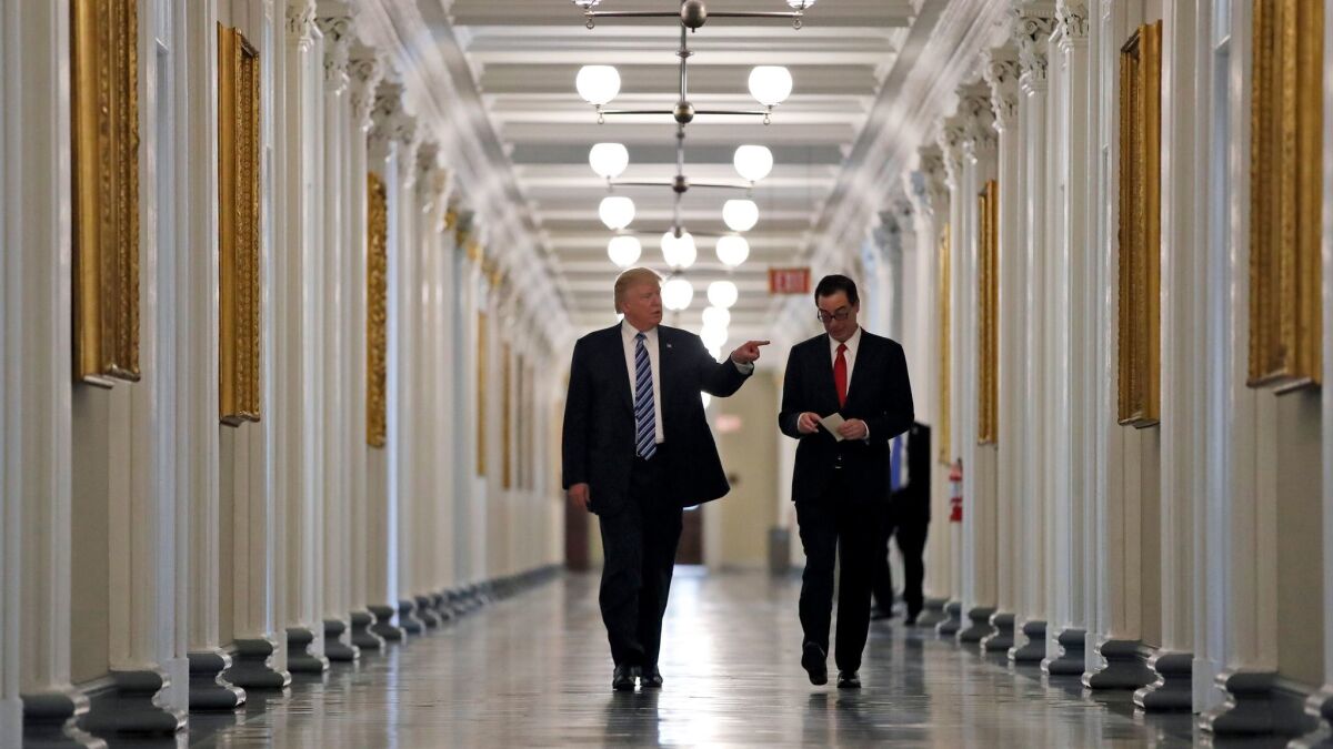 President Trump walks with Treasury Secretary Steven T. Mnuchin at the Treasury Department on April 21.