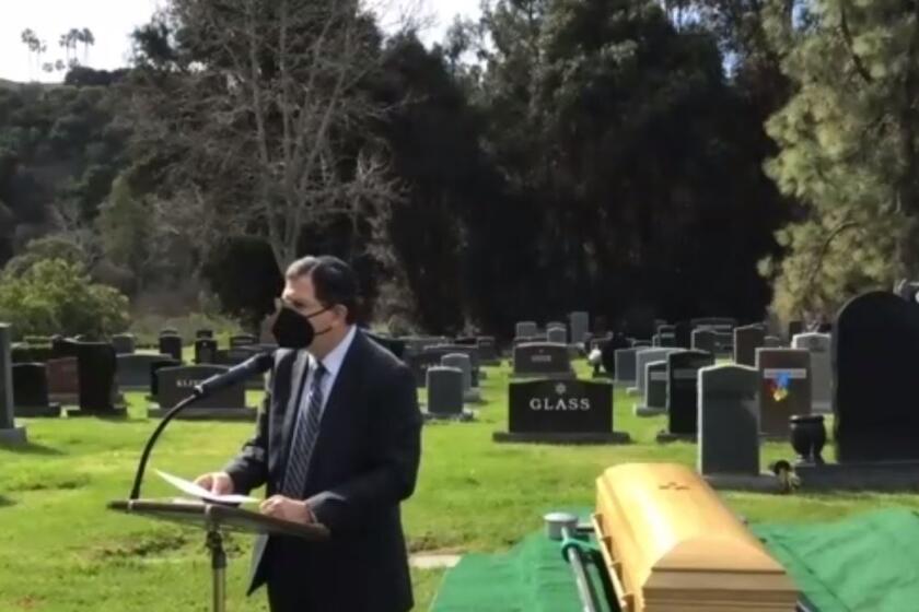 Rabbi Ron Shulman presiding over a funeral at a local cemetery