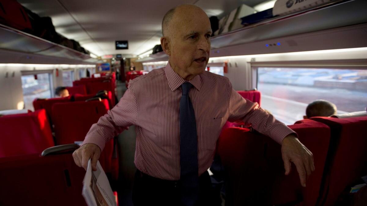 Gov. Jerry Brown speaks to journalists on board a high-speed train during his last visit to China in 2013.