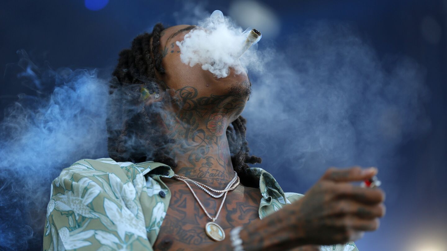 Rapper Wiz Khalifa lights up on stage at KAABOO Del Mar on Sunday, September 16, 2018. (Photo by K.C. Alfred/San Diego Union-Tribune)