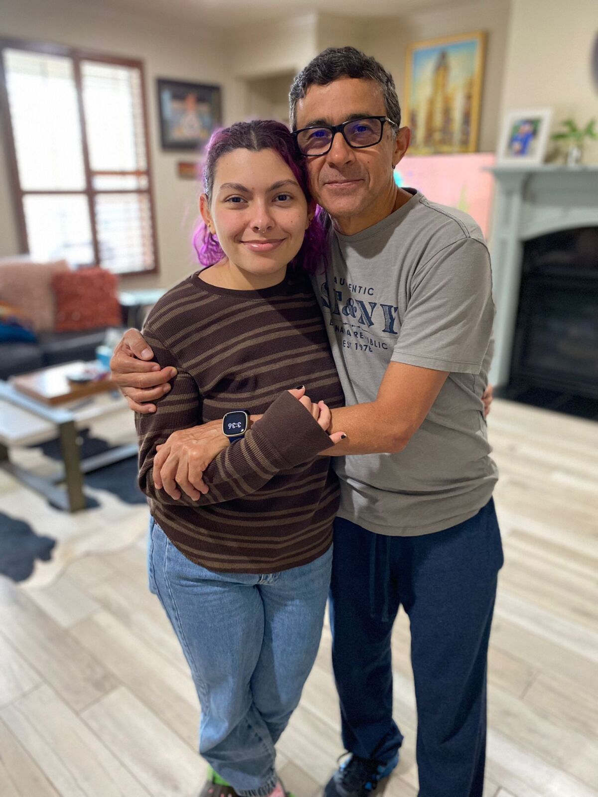 Gustavo Cardenas with his daughter in their home in Houston.