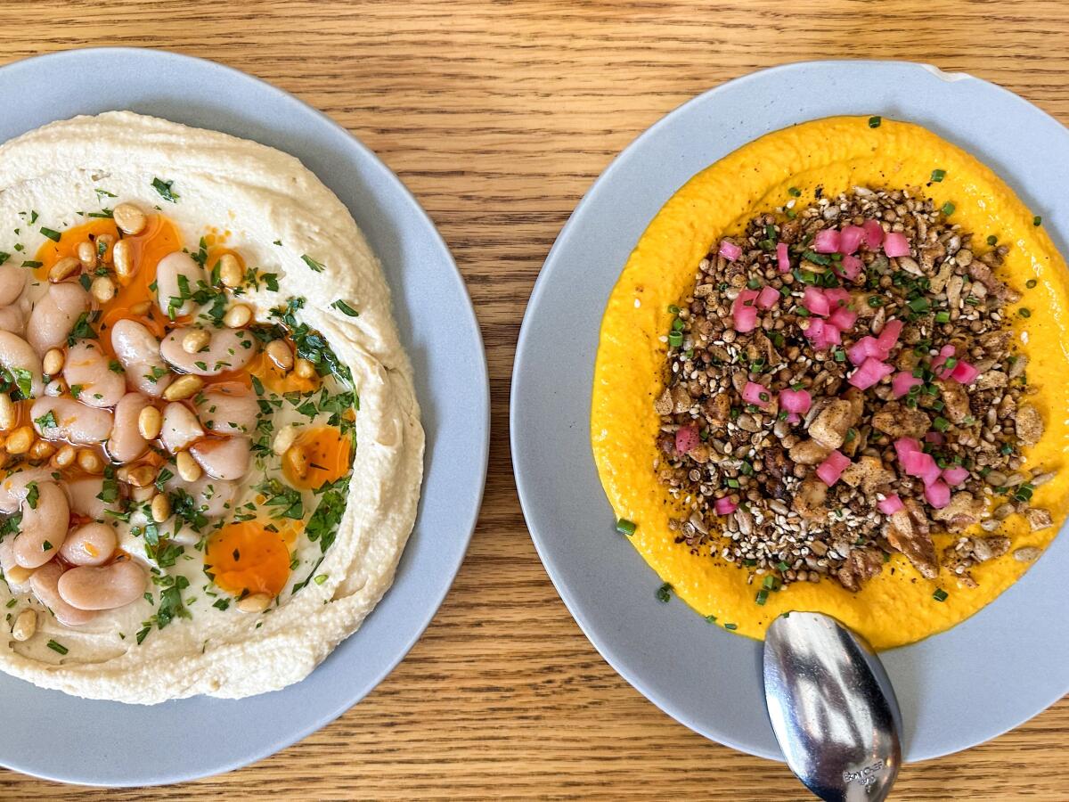 Hummus with pickled beans and carrot dip with salsa macha and crushed walnuts at Botanica.