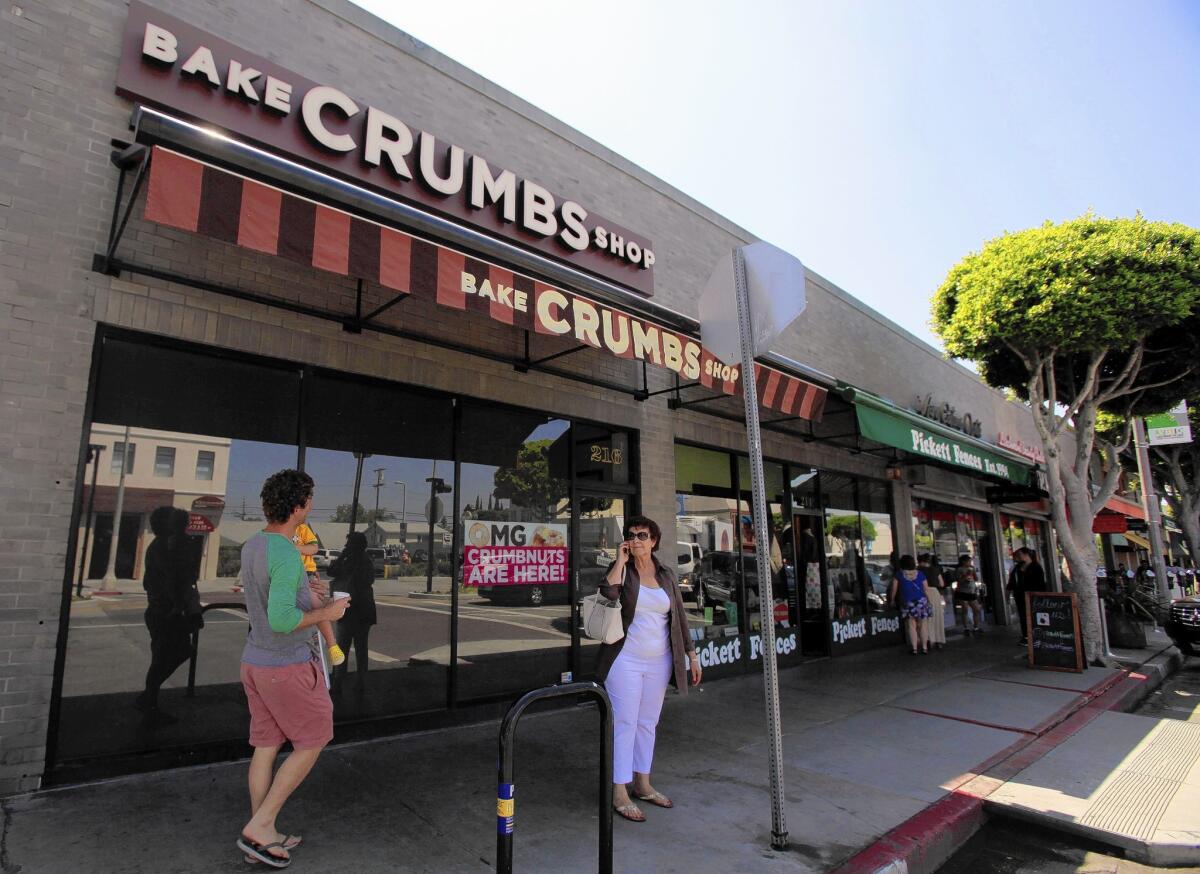 People walk past the closed Crumbs Bake Shop on Larchmont Boulevard in Los Angeles, the chain's last remaining store in the L.A. area.