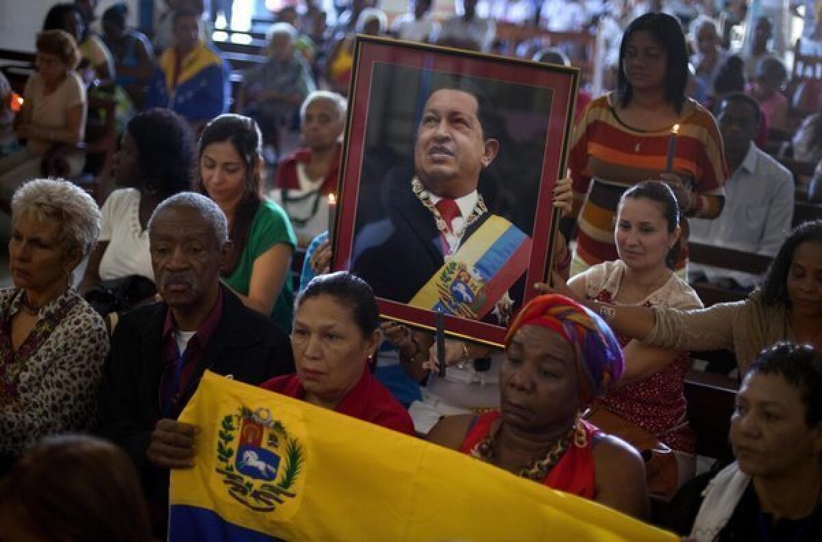 Venezuelan embassy workers in Havana, Cuba, pray for ailing President Hugo Chavez during the monthly Catholic service devoted to the sick at the Church of Our Lady in Regla.