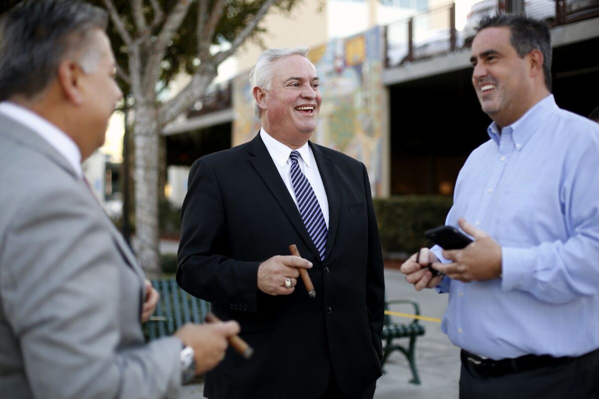 Mario Guerra, center, former mayor of Downey and treasurer of the California Republican party, with Rick Rodriguez, left, a council member-elect, and Alex Saab, mayor of Downey, in Downey.