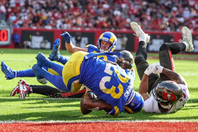 Tampa, Florida, Sunday, January 23, 2022 - Los Angeles Rams running back Cam Akers (23) fumbles at the goal line as Tampa Bay Buccaneers safety Antoine Winfield Jr. (31) tackles him for a turnover in the NFC Divisional Playoff at Raymond James Stadium. (Robert Gauthier/Los Angeles Times)