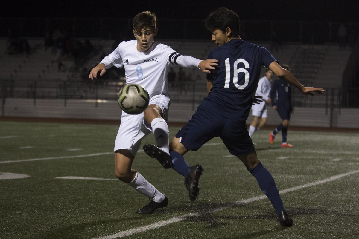 Corona del Mar's Aidan Holmes, left, shown gaining possession of the ball in a Dec. 19, 2019 match against University, led the Sea Kings past Edison 2-1 on Wednesday.