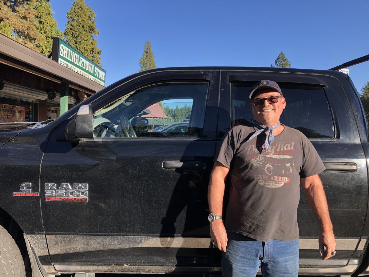 Victor Castellanos stands next to his Dodge Ram in Shingletown, Calif.