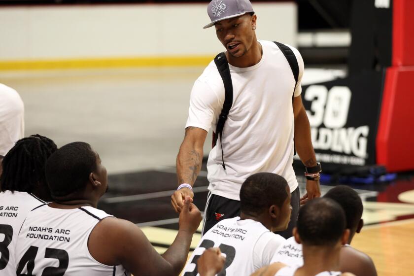 Derrick Rose greets players before a Noah's Arc Foundation One City basketball tournament organized by Joakim Noah at the United Center. The players in the tournament were 18-24 years old and are from South and West Side neighborhoods of Chicago.