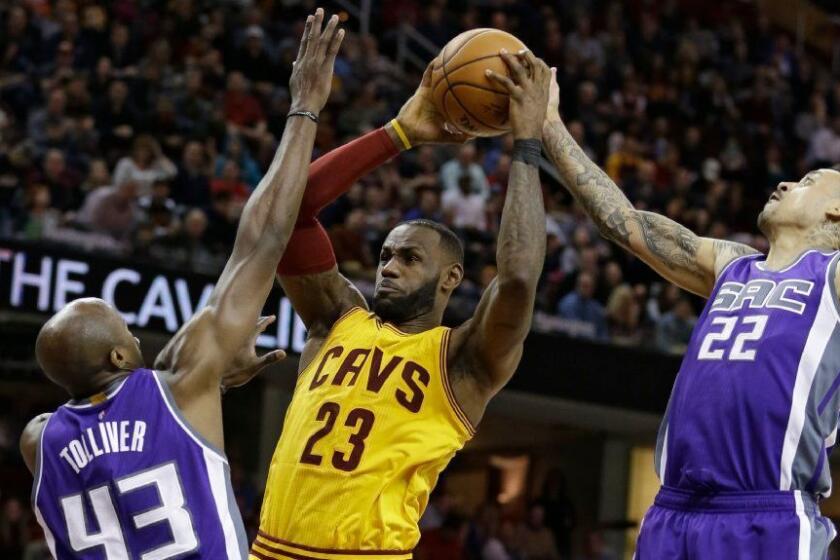 Cleveland forward LeBron James is defended by Sacramento's Anthony Tolliver (43) and Matt Barnes (22) during a game on Jan. 25.