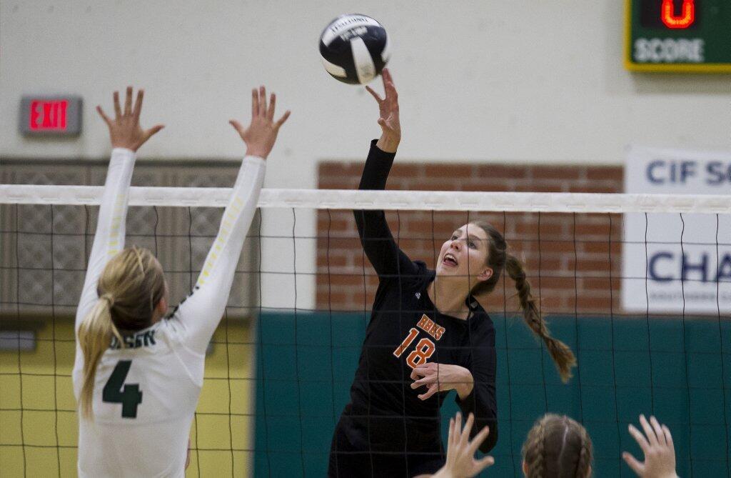 Huntington Beach's Julia Jackson hits the ball against Edison's Hannah Phair