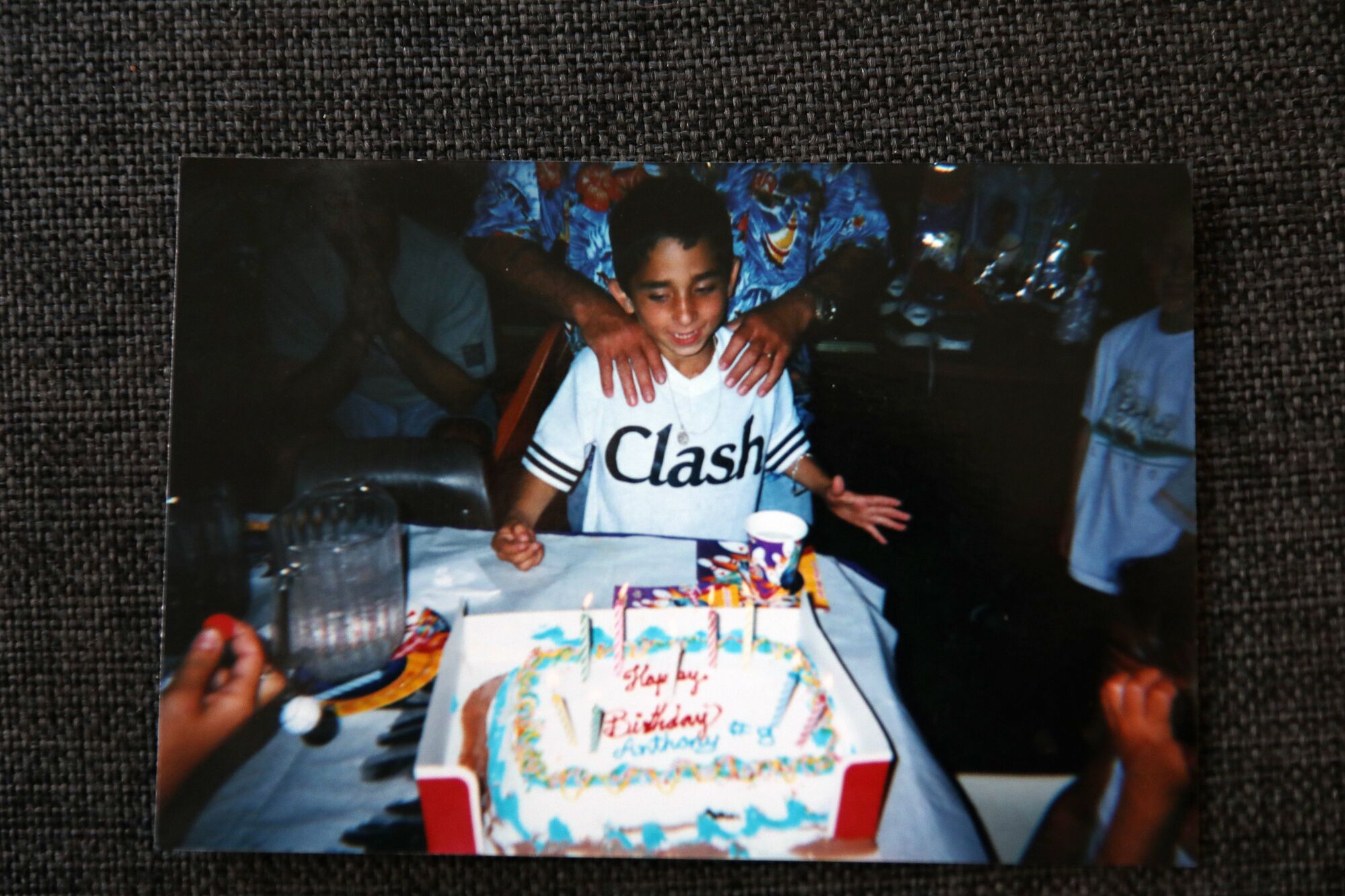 A boy in front of a birthday cake