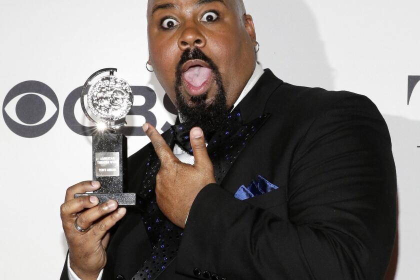 James Monroe Iglehart, who played the genie in the Broadway version of Disney's "Aladdin," holds his Tony Award for actor in a featured role in a musical.