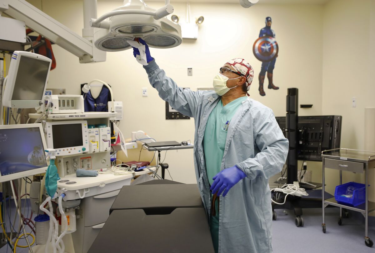 Environmental services attendant Jesse Gonzalez cleans an operating room at Rady Children's Hospital in San Diego.