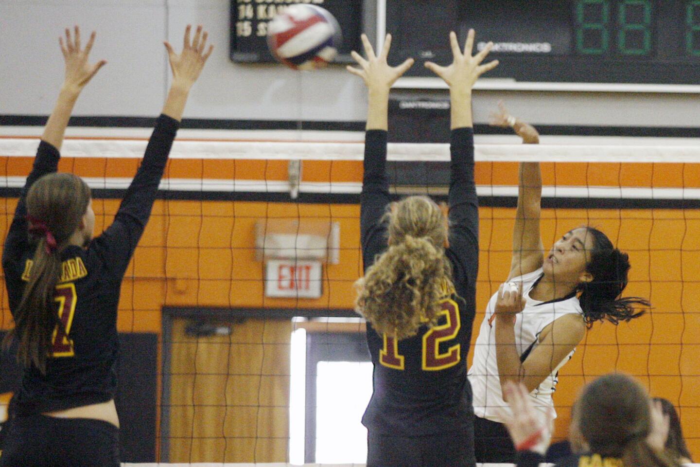 South Pasadena's Samantha Figueroa, right, spikes the ball during a game against La Canada at South Pasadena High School on Thursday, September 27, 2012.