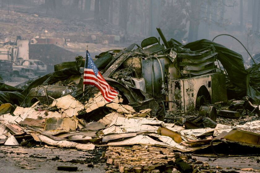 An American flag is placed on a burned fire engine at a burned fire station in downtown Greenville, California on August 7, 2021. - The Dixie Fire has now ravaged 446,723 acres in four counties, up from the previous day's 434,813. That area is larger than Los Angeles -- and has surpassed the sweep of the vast Bootleg Fire in southern Oregon. (Photo by JOSH EDELSON / AFP) (Photo by JOSH EDELSON/AFP via Getty Images)