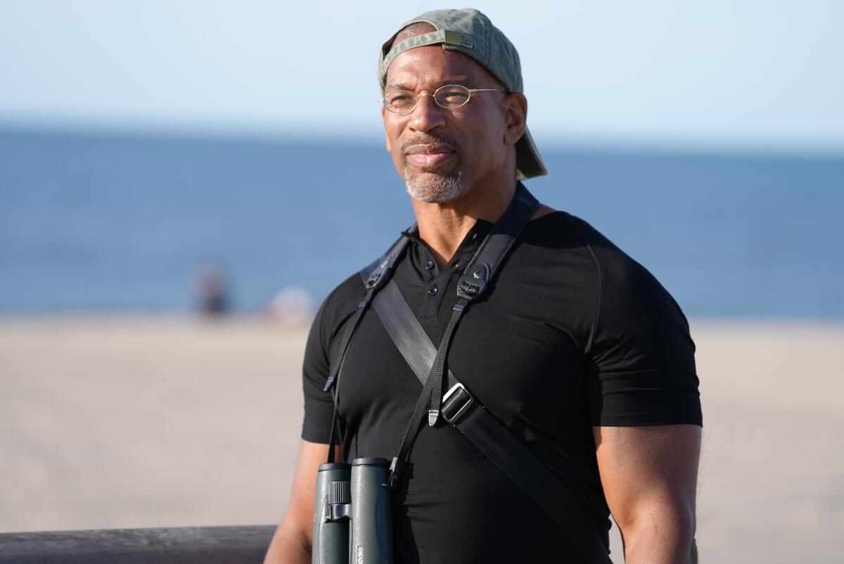 Christian Cooper, author of "Better Living Through Birding," surveys the beach at Fort Tilden.