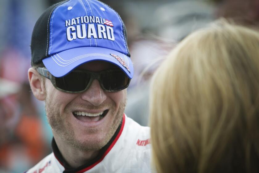Dale Earnhardt Jr. smiles as he waits for the start of a NASCAR Sprint Cup Series race in Dover, Del.