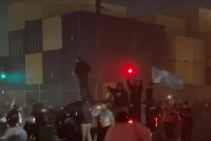 Dozens of people were seen in a video running into an intersection during a street takeover just outside of Compton on Sunday evening, narrowly avoiding cars that swirled along the asphalt.