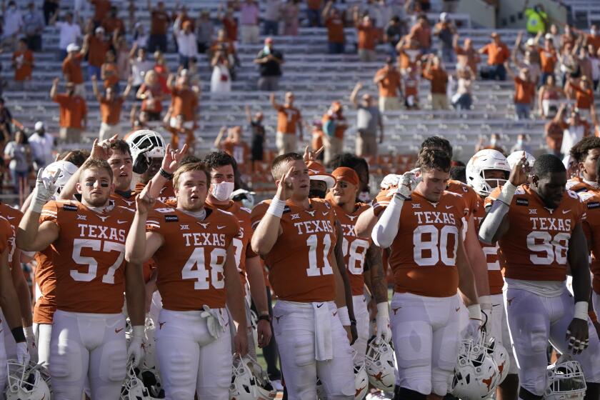 Texas players sing "The Eyes of Texas" after a game against West Virginia on Nov. 7 in Austin.