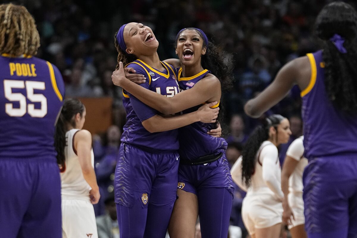 LSU's Angel Reese and LaDazhia Williams react during the second half of an NCAA Women's Final Four semifinals basketball game against Virginia TechFriday, March 31, 2023, in Dallas. (AP Photo/Tony Gutierrez)