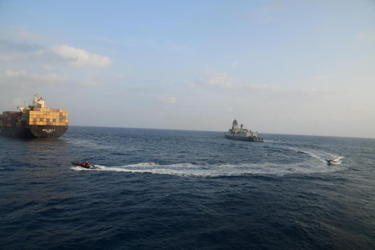 A firefighting team from Indian Navy vessel INS Kolkata responds to a fire on Liberian-flagged Merchant ship MSC Sky II.