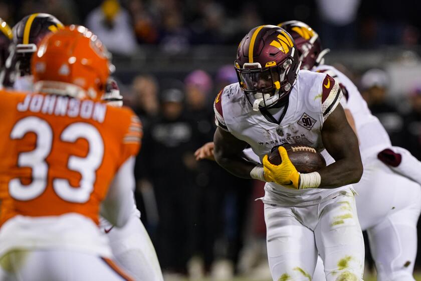 Washington Commanders running back Brian Robinson Jr. runs for a touchdown against the Chicago Bears in the second half of an NFL football game in Chicago, Thursday, Oct. 13, 2022. (AP Photo/Nam Y. Huh)