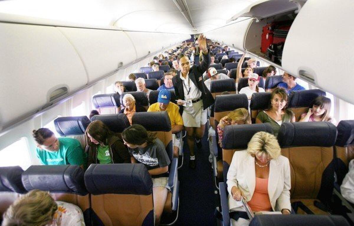 Passengers sit in their assigned seats before take-off at San Diego's Lindburgh Field Airport in San Diego, California.