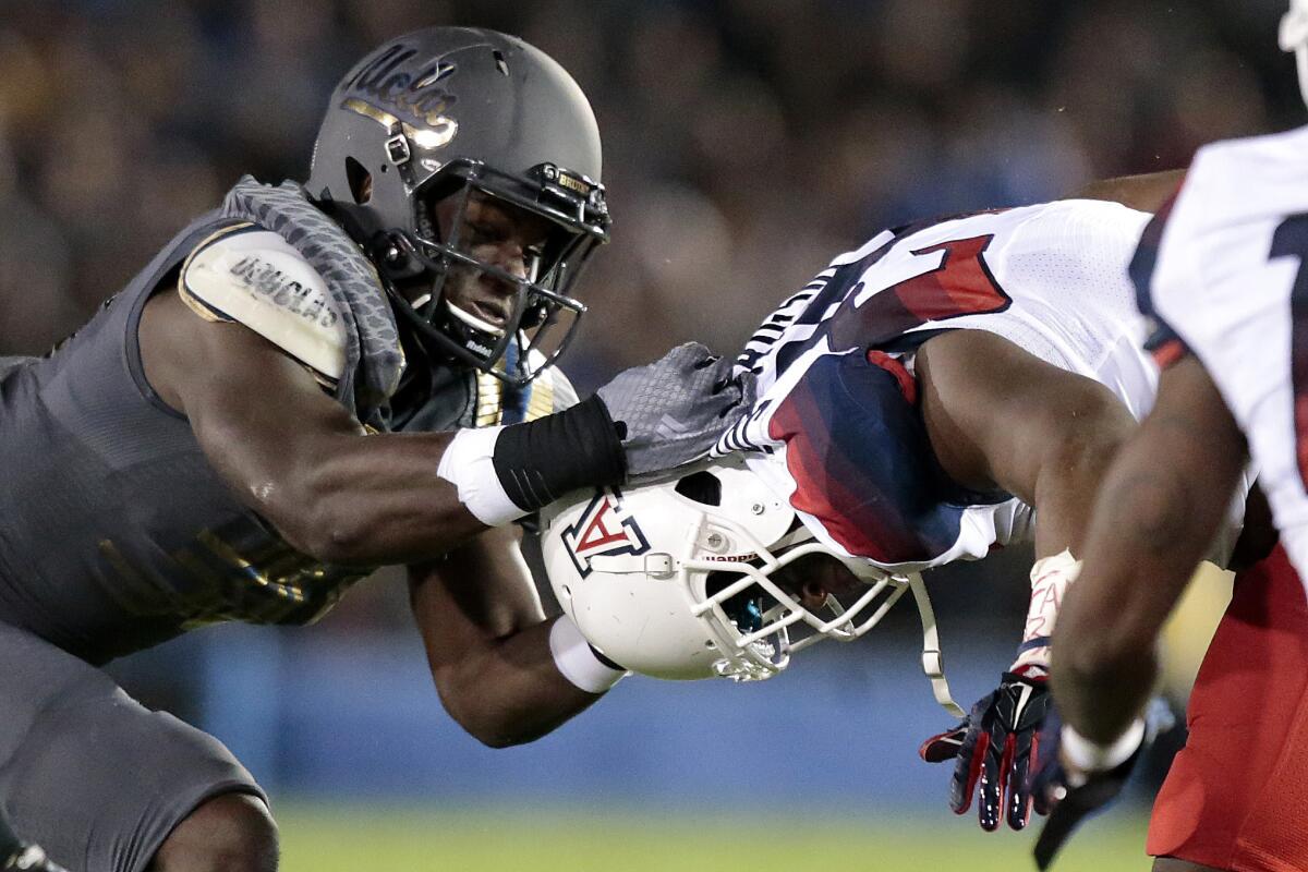 UCLA linebacker Myles Jack is called for a personal foul as he tackles Arizona running back Terris Jones-Grigsby by the helmet at the Rose Bowl on Nov. 1.