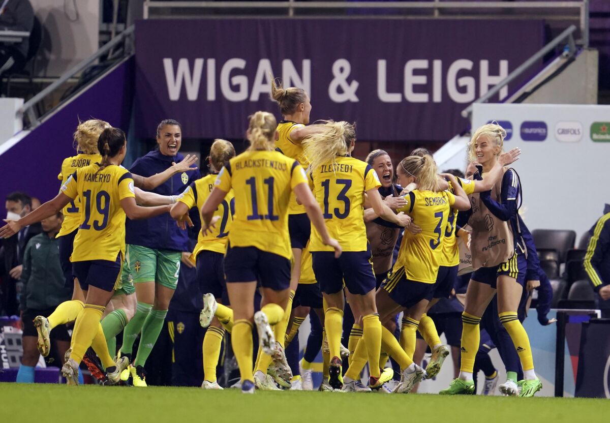 Sweden's Linda Sembrant celebrates with teammates after scoring her side's first goal during the Women Euro 2022 quarter final soccer match between Sweden and Belgium at Leigh Sports Village, in Leigh, Manchester, England, Friday, July 22, 2022. (AP Photo/Jon Super)