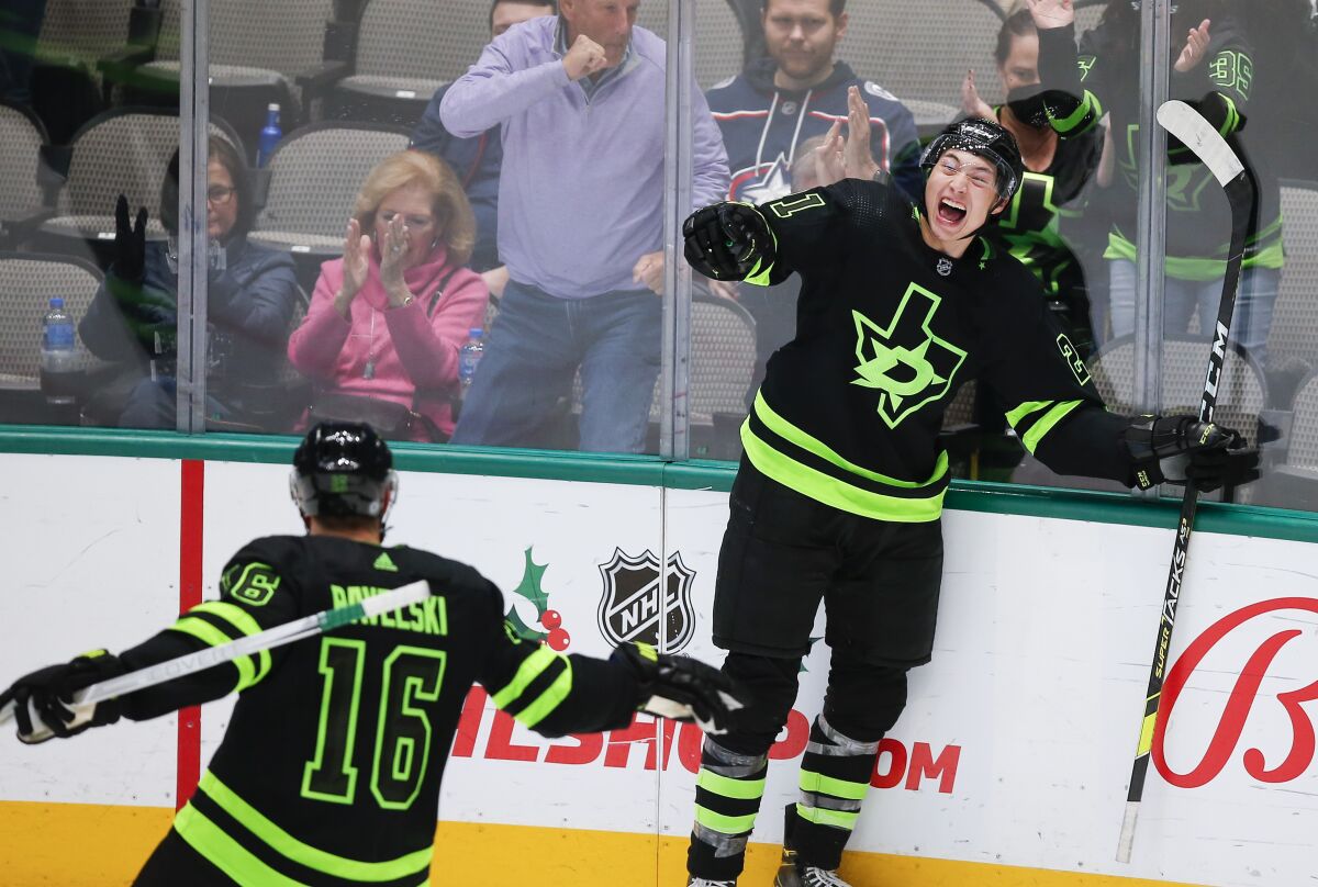 Two hockey players celebrate on the ice