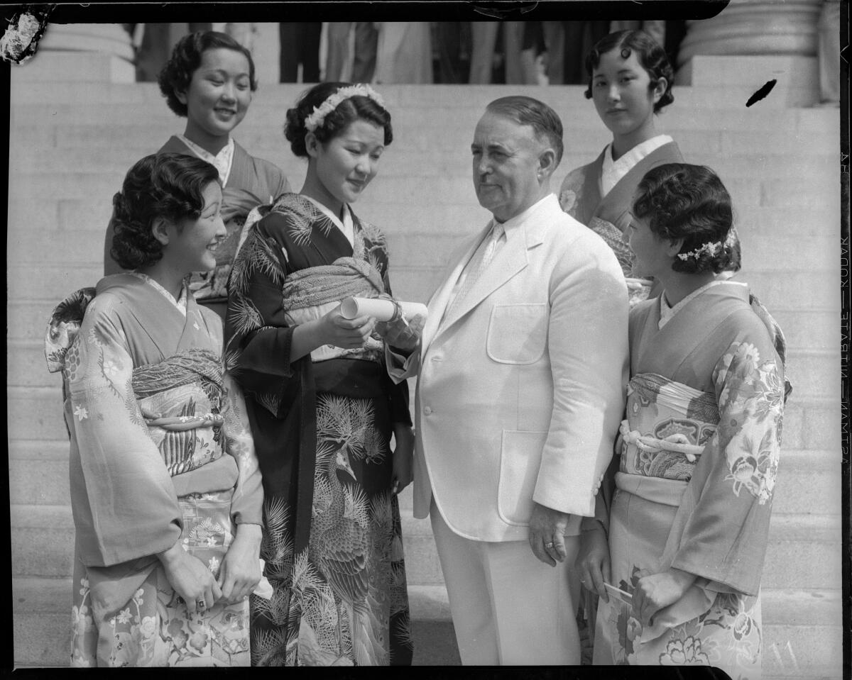 Women dressed in traditional Japanese attire with Los Angeles Mayor Frank Shaw, in an all-white suit, in 1935.