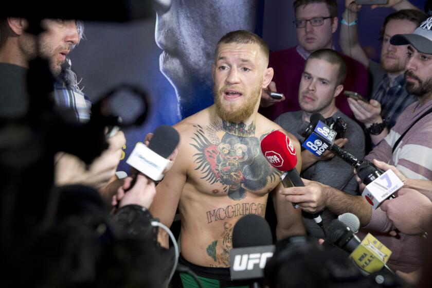 UFC featherweight champion Conor McGregor talks with reporters during open workouts for UFC 196 on Mar. 2.